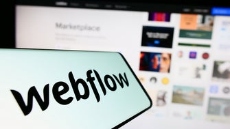 webflow logo with computer screen out of focus in background