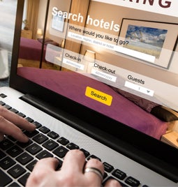 Person browses a hotel booking site on their laptop