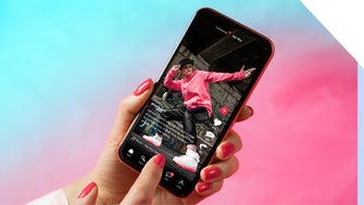 Phone shows a short-form video on social media