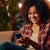 Woman smiles at her cell phone while relaxing