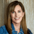 Headshot of Lisa smiling wearing a blue jean jacket