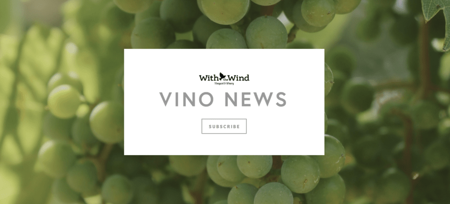 White box inviting visitors to subscribe to With the Wind's newsletter with a background image of green grapes